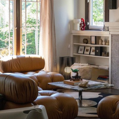 Tommy Lei's home in Los Angeles, featuring secondhand leather sofas and a pedestal coffee table.