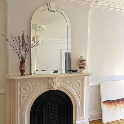Beth Nicole Newman's fireplace featuring a secondhand mirror from Kaiyo above the mantel.