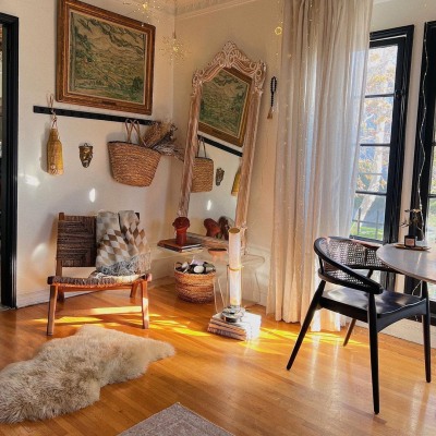 Winter light hitting the corner of hotsundayhome's house, which features a secondhand mirror and chairs.
