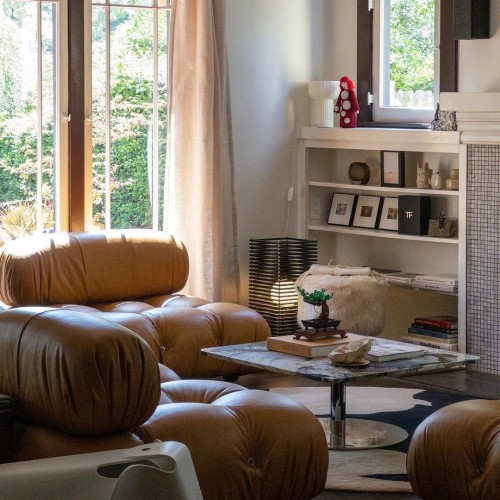 Tommy Lei's home in Los Angeles, featuring secondhand leather sofas and a pedestal coffee table.