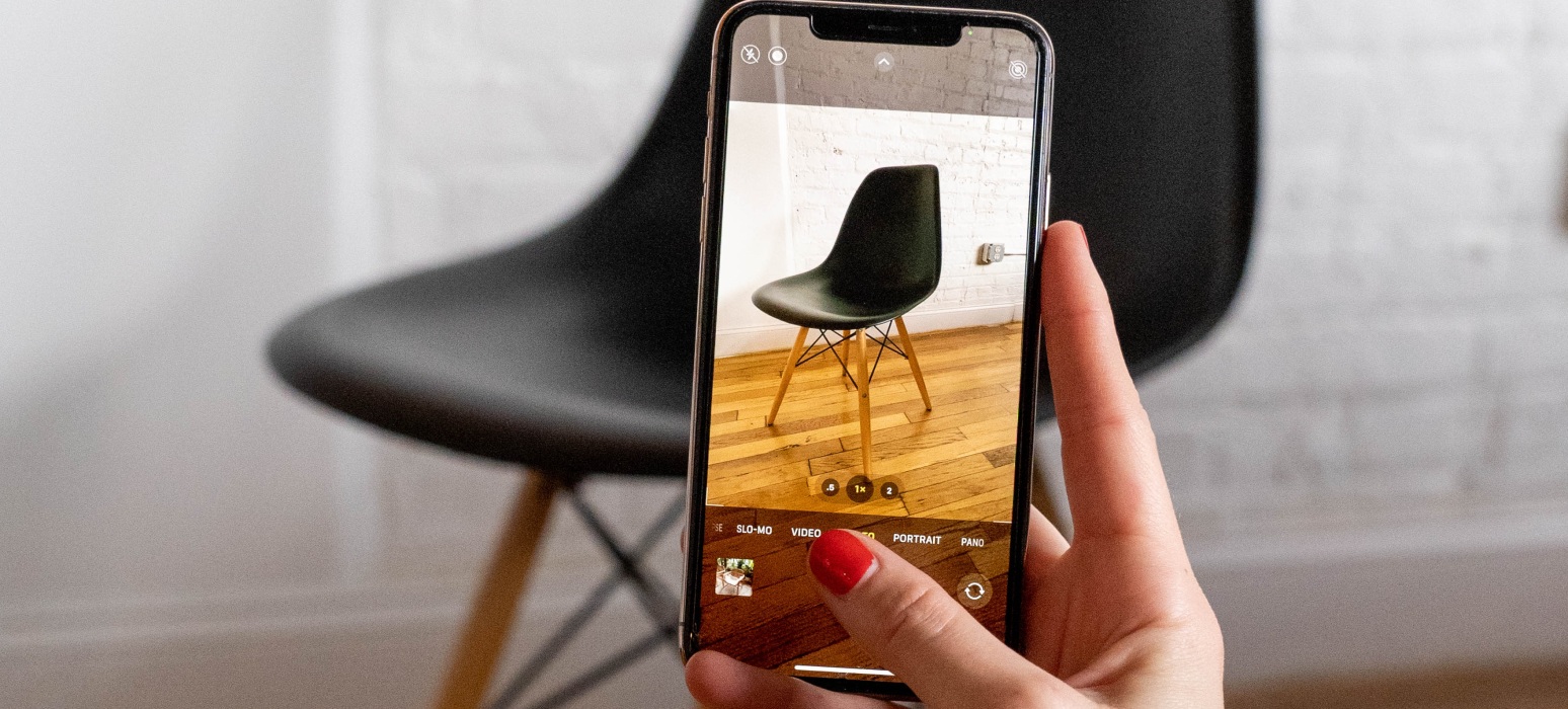 Image of phone taking photo of chair